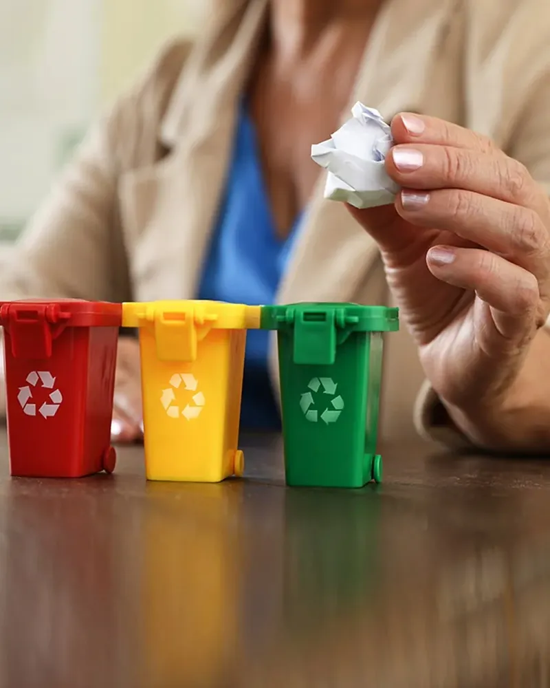 Waste being sorted into small recycling bins