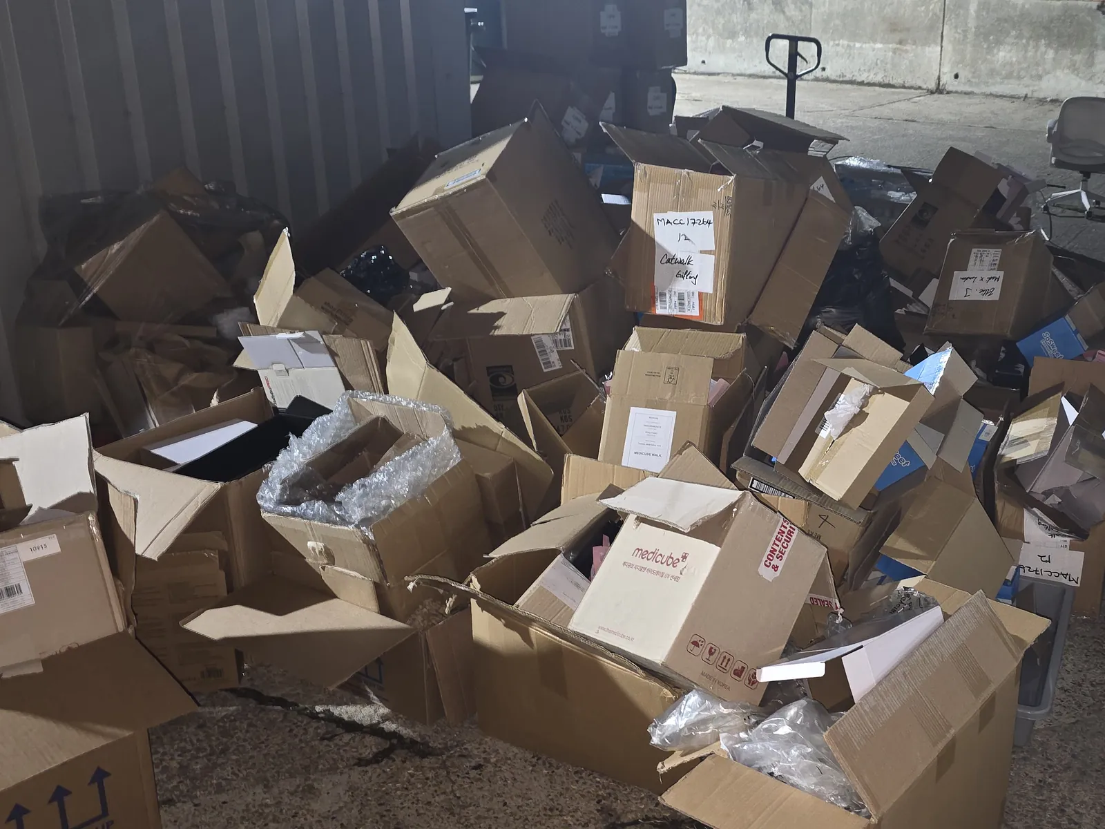 Cardboard collected for recycling, loaded next to the van