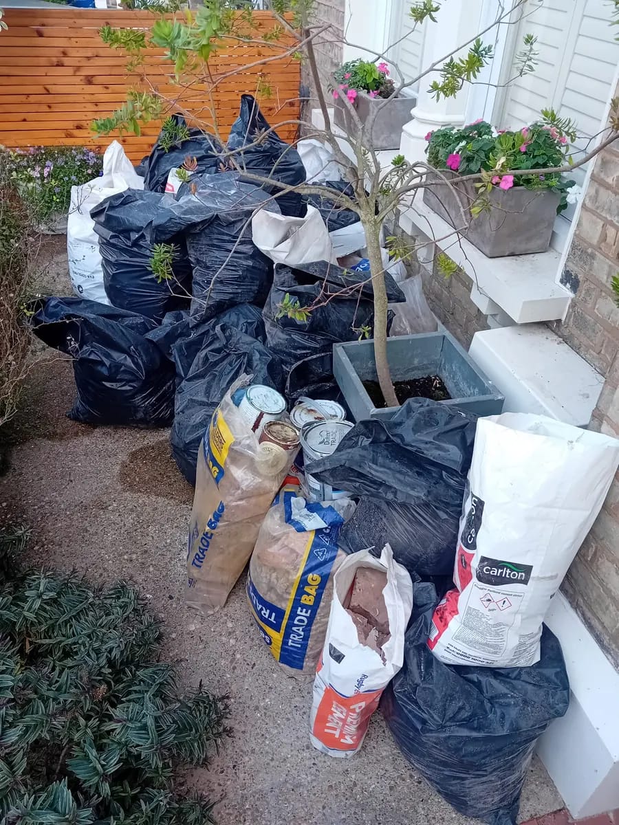 Builders’ bags of waste in a front garden ready for collection