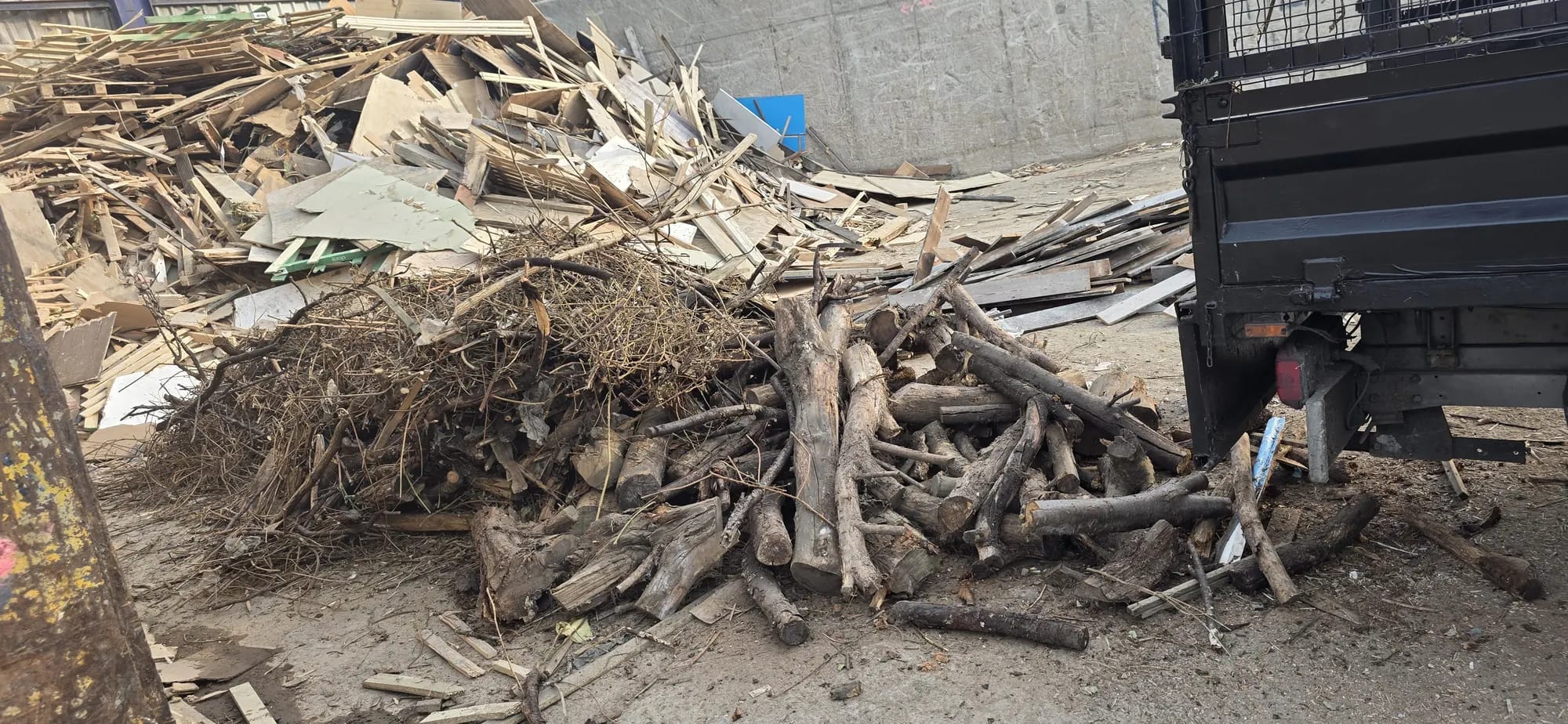 Pile of timber offcuts and branches ready for collection from a site